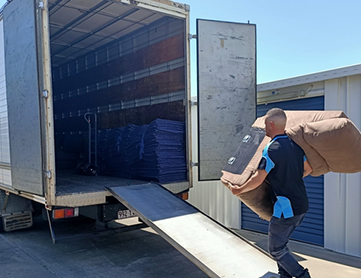 removalist putting furniture into the back of the truck